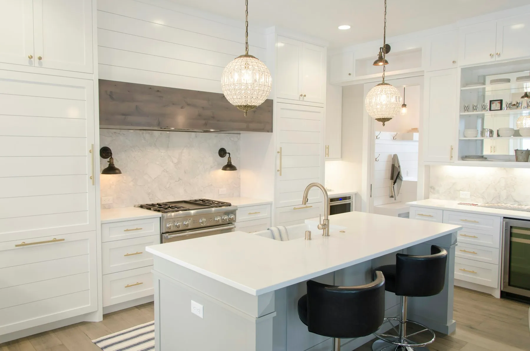 White cottage kitchen with a subway-tile backsplash and gas range